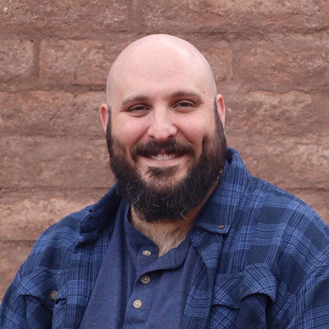 A man with a beard and blue shirt